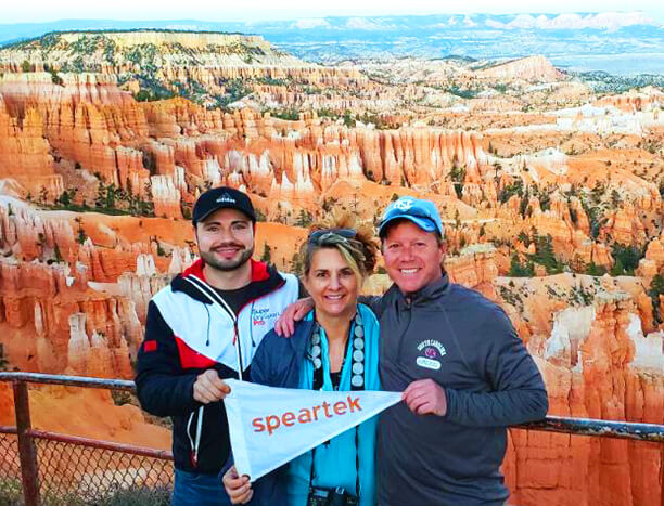 Saul, Andrea and Derek Posing with a Speartek Flag at National Park